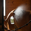 Natural fly spray being sprayed onto horse for fly control